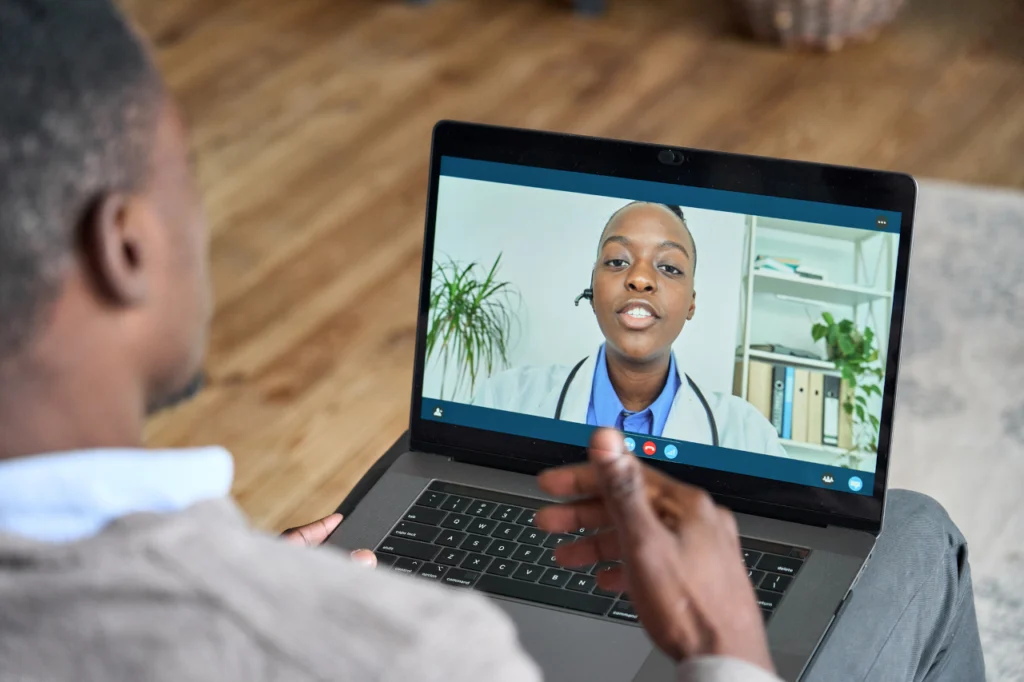 A patient speaks with a doctor in a telehealth meeting