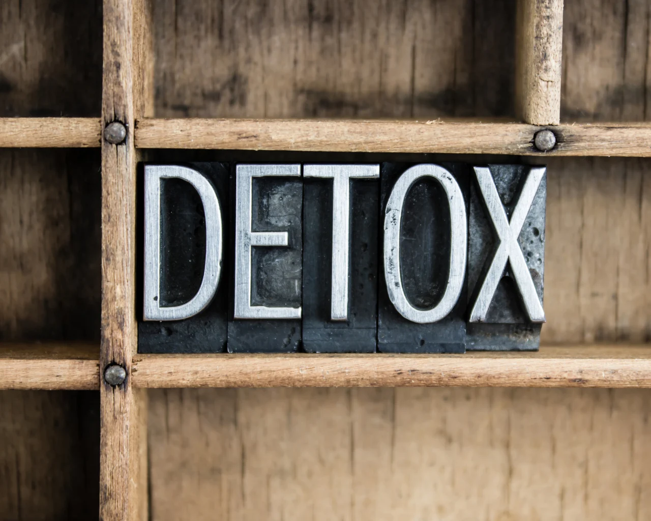 the word "DETOX" spelled out in wooden letters