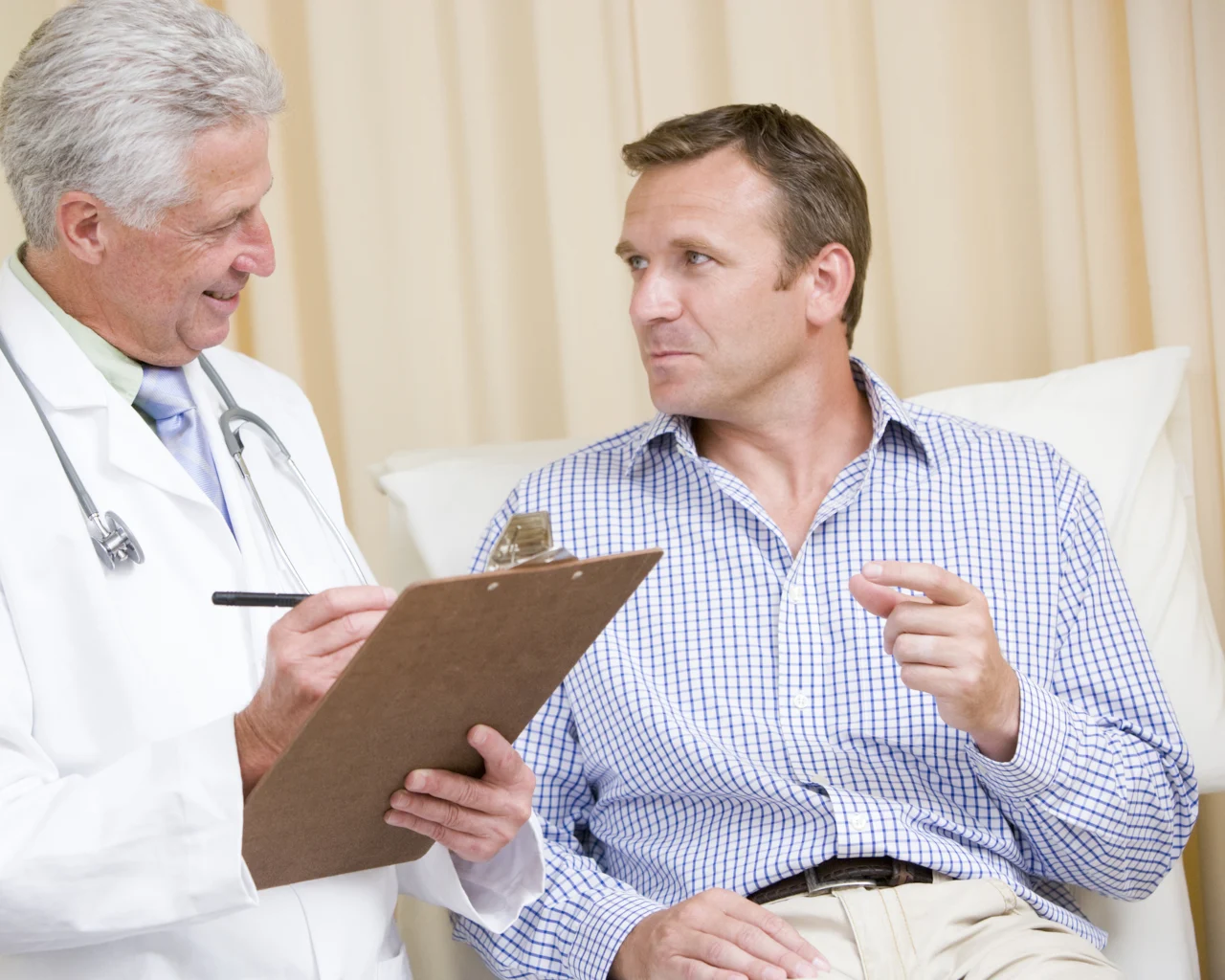A man speaks with a doctor during his appointment