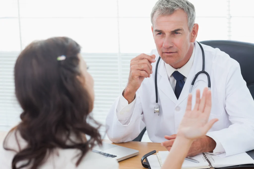 A doctor speaks with a patient during a consultation