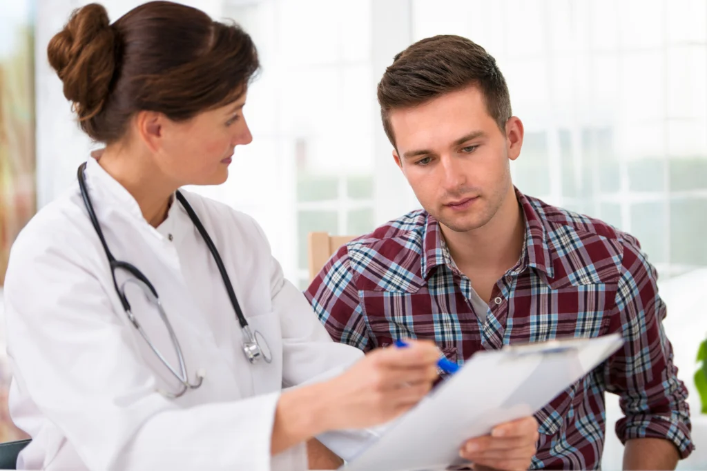 A doctor speaks with a patient during a consultation